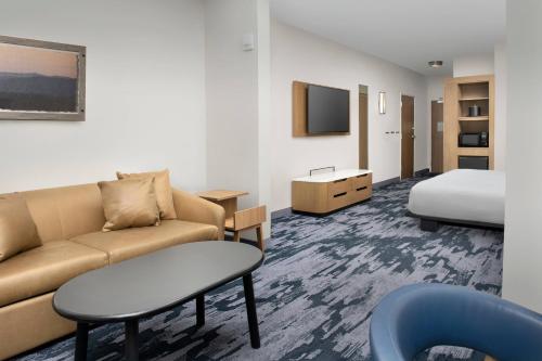a hotel room with a couch and a bed at Fairfield Inn & Suites by Marriott Santa Rosa Rohnert Park in Rohnert Park