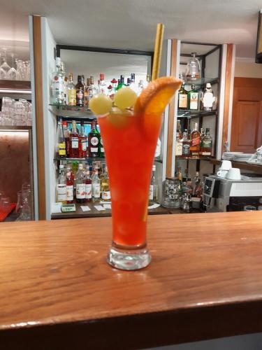 a drink with an orange slice on a bar at Pension Jana - Wellness in Jilemnice