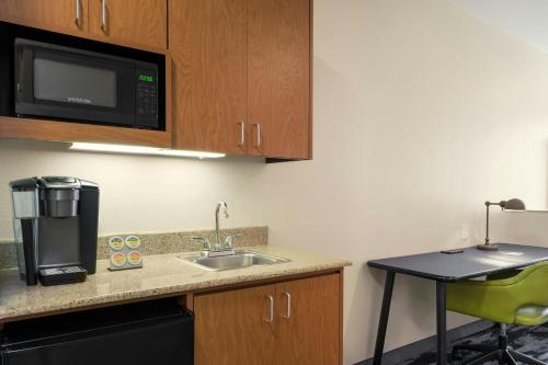 a kitchen with a sink and a microwave at Fairfield Inn & Suites by Marriott Fairfield Napa Valley Area in Fairfield