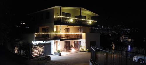 a building with christmas lights on it at night at Marlingsuites - Vinea - Wieser Josef - Marling in Marlengo