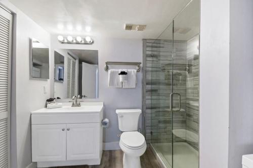 a bathroom with a toilet and a glass shower at Oceanside complex M33 1 Bed 1 Bath Heated Pool in Saint Augustine