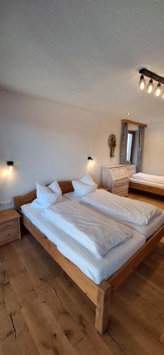 a large wooden bed in a room with at Haus Joelblick und Haus Oberadelsber in Oberau
