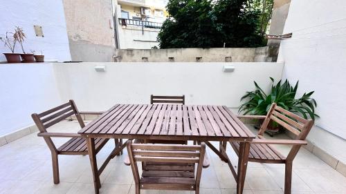 a wooden table and two chairs on a patio at Centrally Located Gzira in Il-Gżira