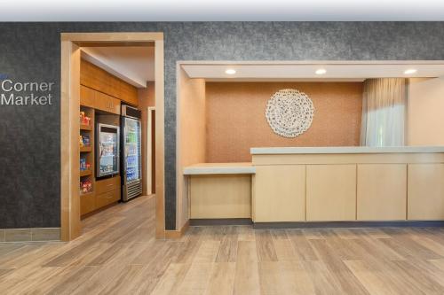 an entrance to a store with a counter in a lobby at Fairfield Inn & Suites Houston Humble in Humble