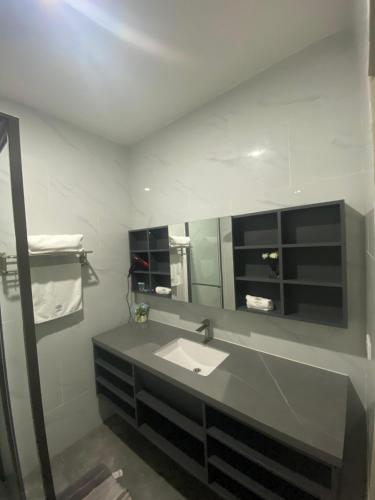a bathroom with a sink and a mirror at Hotel Plaza Corotú-HPC in Santiago