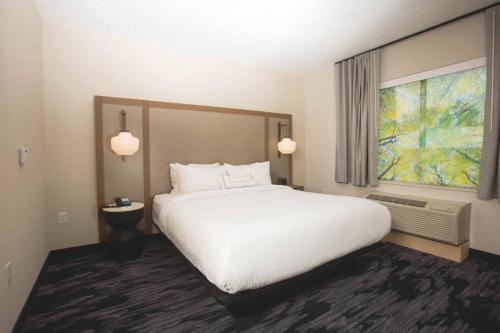 a bedroom with a large white bed and a window at Fairfield Inn & Suites by Marriott Philadelphia Broomall/Newtown Square in Broomall