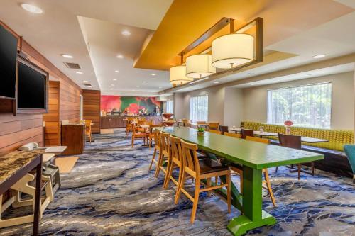 a conference room with a green table and chairs at Fairfield Inn Myrtle Beach North in Myrtle Beach