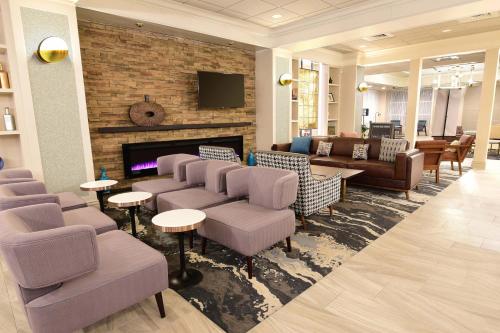a lobby with couches and chairs and a fireplace at Four Points by Sheraton York in York