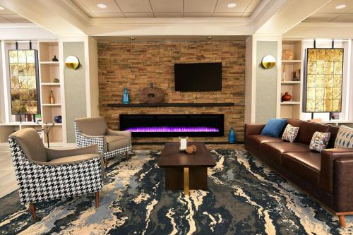 a living room with a couch and a fireplace at Four Points by Sheraton York in York