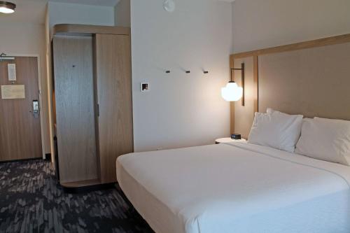 a large white bed in a hotel room at Fairfield by Marriott Inn & Suites St Louis South in Saint Louis