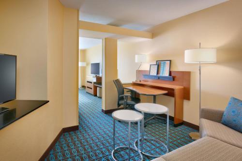 a hotel room with a desk and a room at Fairfield Inn & Suites Idaho Falls in Idaho Falls