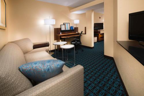 a hotel room with a couch and a desk at Fairfield Inn & Suites Idaho Falls in Idaho Falls