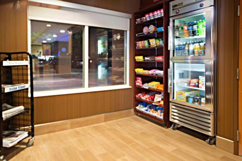 a store aisle with a refrigerator and a window at Fairfield Inn & Suites Idaho Falls in Idaho Falls