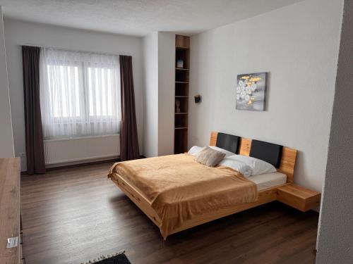a bedroom with a bed and a large window at Casa Leone Hotel&Restaurant in Popova Shapka