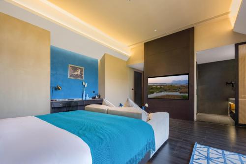 a hotel room with a large bed and a bathroom at Dianpan Miying Hotel in Shizui Zhan