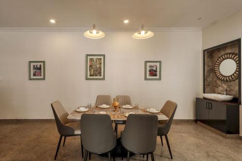 a dining room with a table and chairs at Emerlad Apartment 201 Nr MG Road Housekeeping in Bengaluru