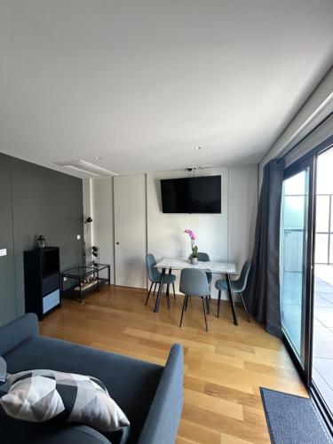 a living room with a couch and a table at New apartment with large terrace in Matosinhos in Matosinhos
