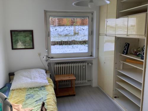 a small bedroom with a bed and a window at Burghof Altenbüren in Brilon