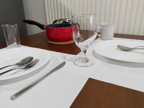 a table with two plates and a wine glass at APT at G-207 in SMDC Cheer Residences in Marilao