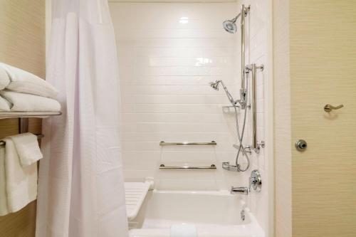 a white bathroom with a shower and a bath tub at Fairfield Inn & Suites by Marriott Panama City Beach in Panama City Beach