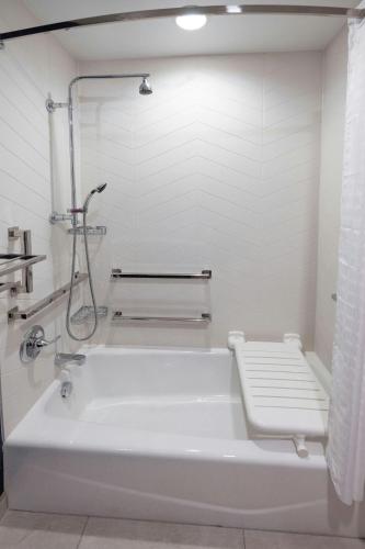 a white bath tub in a bathroom with a shower at Fairfield Inn & Suites Arkadelphia in Arkadelphia