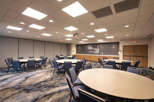 a conference room with tables and chairs and a chalkboard at Fairfield Inn & Suites Arkadelphia in Arkadelphia