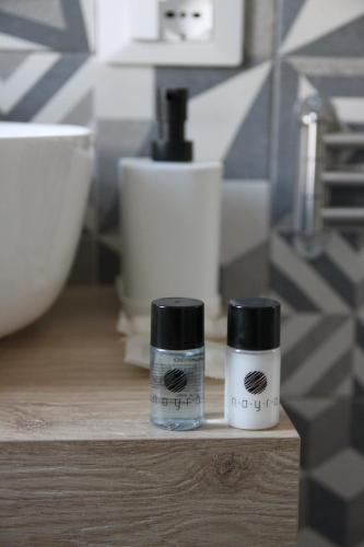 two bottles ofodorizers sitting on a counter in a bathroom at B&B Il Melograno in Valmontone