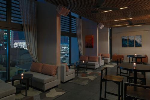 a lobby with couches and tables and windows at Four Points by Sheraton Brisbane in Brisbane