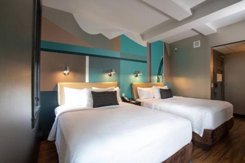 two beds in a hotel room with white sheets at Fairfield Inn & Suites by Marriott Philadelphia Downtown/Center City in Philadelphia