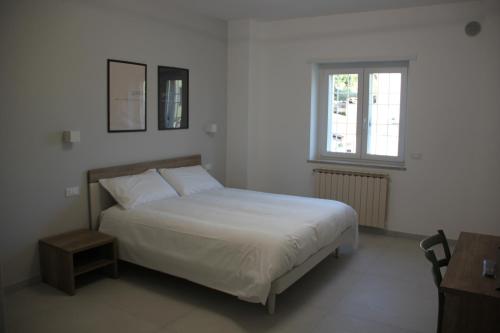 Postel nebo postele na pokoji v ubytování B&B Il Melograno