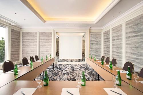 a conference room with tables and chairs and a corridor at Four Points by Sheraton Bandung in Bandung