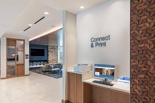 an office with a desk with a computer on a wall at Fairfield Inn & Suites Houston Memorial City Area in Houston
