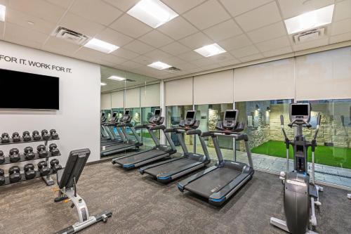 a gym with a row of treadmills and machines at Fairfield Inn & Suites Houston Memorial City Area in Houston