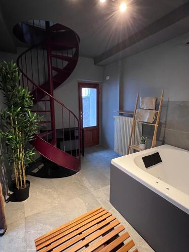 a living room with a spiral staircase in the background at VILLA Como, Jacuzzi Spa and Private Pool in Blevio