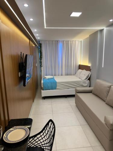 a living room with a bed and a couch at EcoMirage - Flats Premium - Porto de Galinhas in Porto De Galinhas