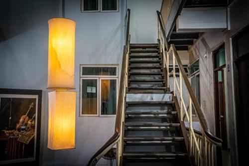 a winding staircase in a building with two windows at The Park House in Male City