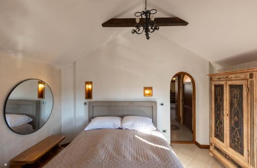 a bedroom with a large bed and a mirror at Royal Casa in Belgrade