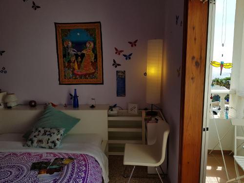 a small bedroom with a bed and a desk at The Magic Dragonfly in Santa Cruz de Tenerife