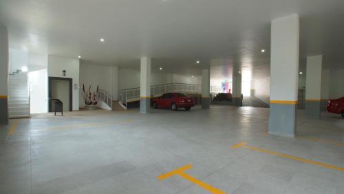 a parking garage with a red car parked in it at Hotel Yekkan in Huauchinango