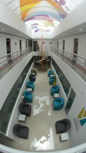 a hospital hallway with chairs and a swimming pool at Hotel Yekkan in Huauchinango