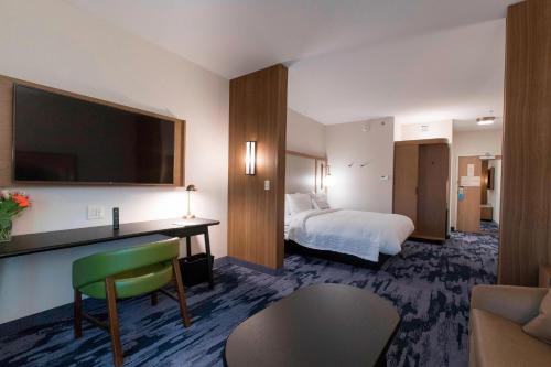 a hotel room with a bed and a desk with a television at Fairfield Inn & Suites by Marriott Philadelphia Valley Forge/Great Valley in Berwyn
