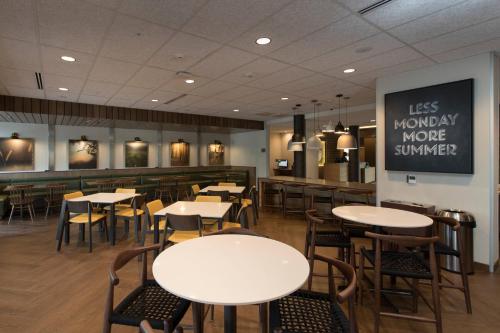 a restaurant with tables and chairs and a counter at Fairfield Inn & Suites by Marriott Philadelphia Valley Forge/Great Valley in Berwyn
