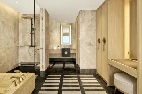 a bathroom with a shower and a sink at JW Marriott Jeju Resort & Spa in Seogwipo