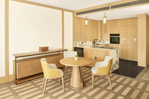 a kitchen with a table and chairs in a room at JW Marriott Jeju Resort & Spa in Seogwipo