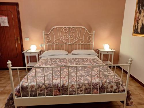 a bedroom with a white bed with two tables at B&B Da Nonna Lucia in Roccascalegna