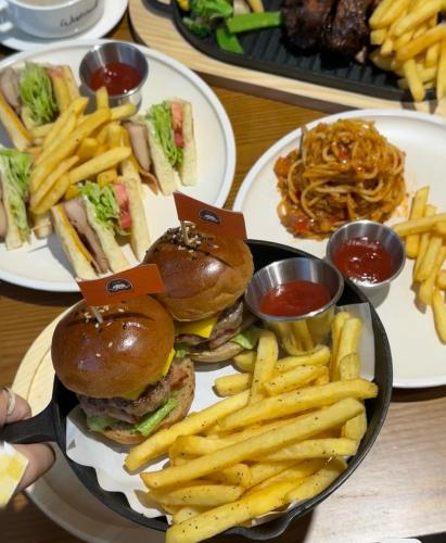 a plate of food with sandwiches and french fries at Dyed Mount Boutique Hotel in Yangshuo