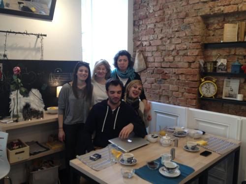 a group of people standing around a table with a laptop at 4citywindows in Zagreb