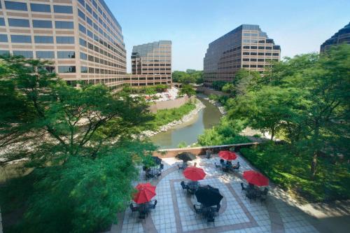 a view of a city with red umbrellas and a river at Chicago Marriott Suites O'Hare in Rosemont