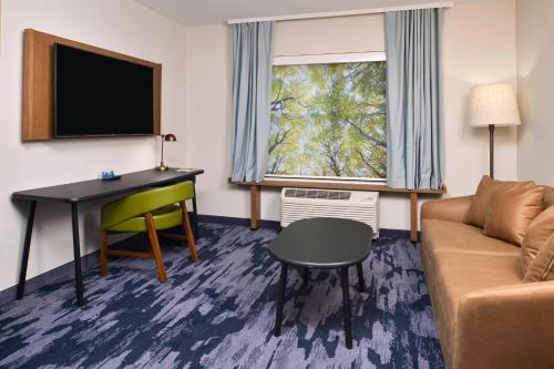 a living room with a couch and a desk at Fairfield Inn & Suites by Marriott Canton in Canton