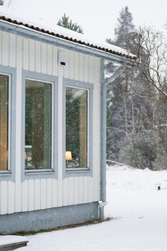 a house covered in snow with a window at Villa Bessberget in Edsbyn